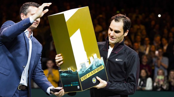 epa06533811 Roger Federer of Switzerland receives a trophy for getting the highest ranking again at the ATP after winning from Robin Haase of the Netherlands in their quarter final match of the ABN AM ...