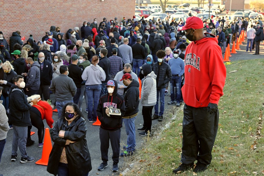 Hundreds wait in lines to vote early at the Douglas County Election Commission office in Omaha, Neb., Saturday, Oct. 31, 2020. (AP Photo/Nati Harnik)