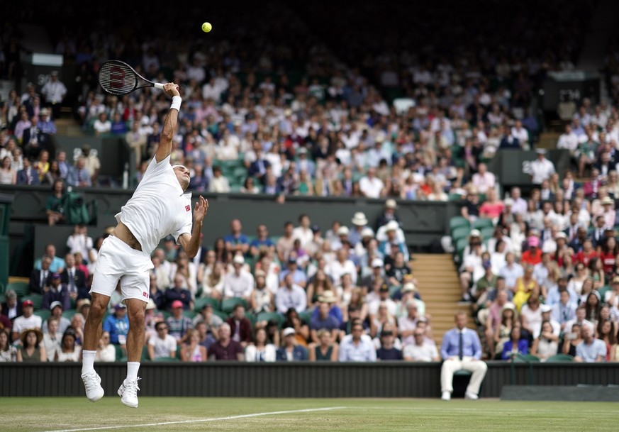 epa07699443 Roger Federer of Switzerland serves to Lucas Puille of France in their third round match during the Wimbledon Championships at the All England Lawn Tennis Club, in London, Britain, 06 July ...