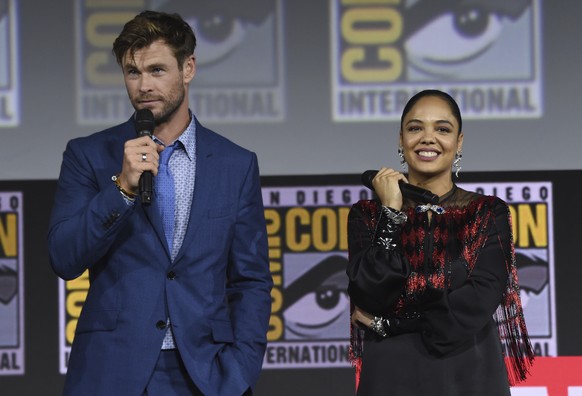 Chris Hemsworth, left, and Tessa Thompson speak during the &quot;Thor Love And Thunder&quot; portion of the Marvel Studios panel on day three of Comic-Con International on Saturday, July 20, 2019, in  ...