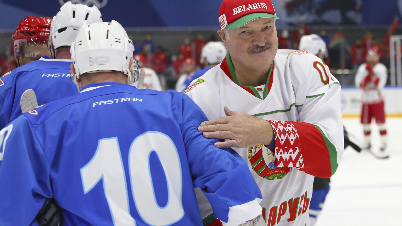 FILE In this file pool photo taken on Saturday, April 4, 2020, Belarusian President Alexander Lukashenko, right, takes part in a hockey match during Republican amateur competitions in Minsk, Belarus.  ...
