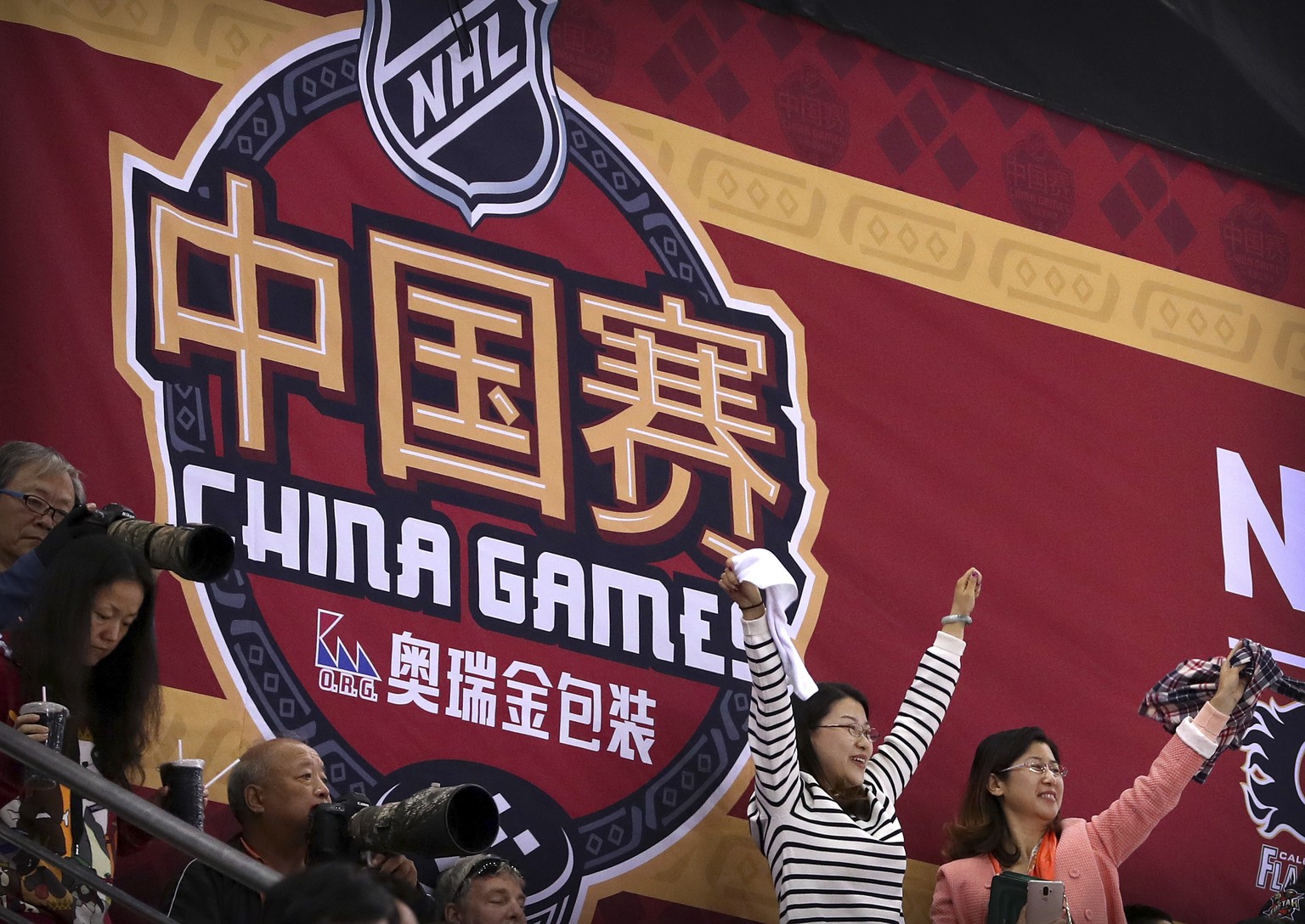 Chinese fans cheer for a Calgary Flames goal during the 2018 NHL China Games hockey game between the Boston Bruins and the Calgary Flames in Beijing, China, Wednesday, Sept. 19, 2018. Boston beat Calg ...