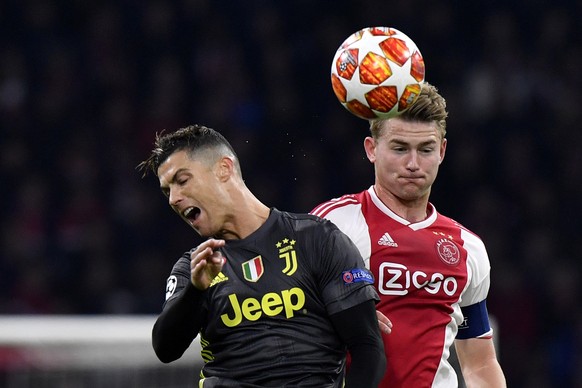 Ajax&#039;s Matthijs de Ligt, right, fights for the ball with Juventus&#039; Cristiano Ronaldo during the Champions League quarterfinal, first leg, soccer match between Ajax and Juventus at the Johan  ...