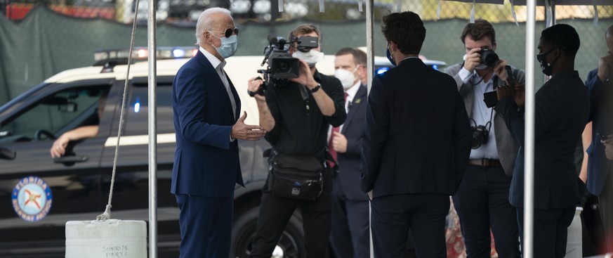 Democratic presidential candidate former Vice President Joe Biden talks back stage before he boards his motorcade after speaking at Miramar Regional Park in Miramar, Fla., Tuesday Oct. 13, 2020. (AP P ...