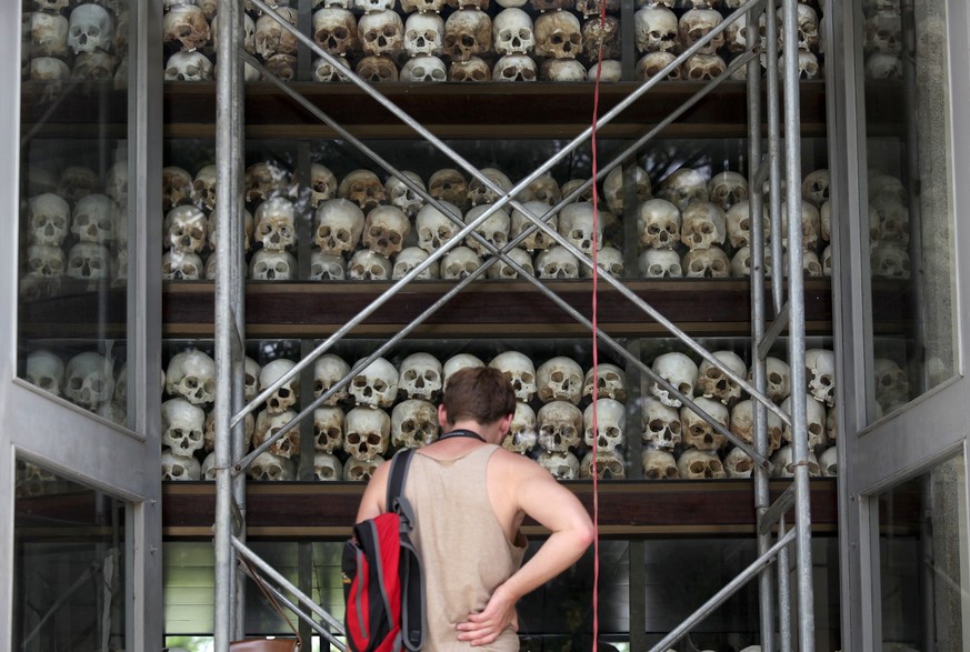 A tourist visits a memorial stupa made with the skulls of more than 8,000 victims of the Khmer Rouge regime at Choeung Ek, a &quot;Killing Fields&quot; site located on the outskirts of Phnom Penh Augu ...