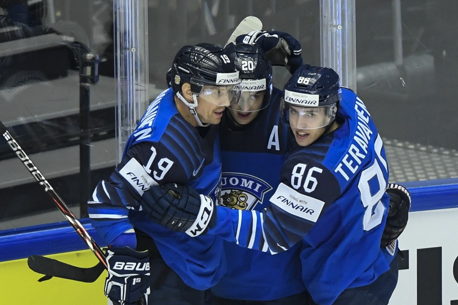 epa06738061 Sebastian Aho (C) of Finland celebrates with teammates Veli-Matti Savinainen (L) and Teuvo Teravainen (R) after scoring a goal during the IIHF World Championship group B ice hockey match b ...
