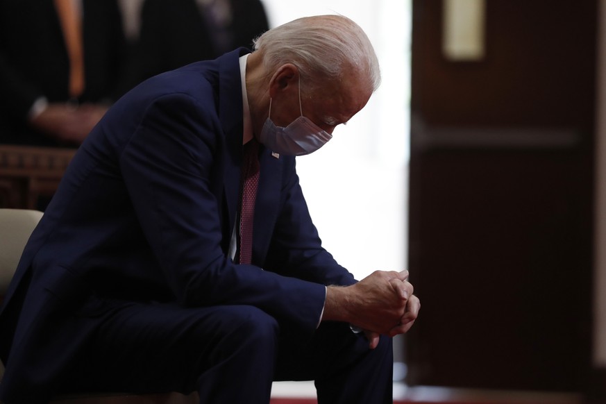 FILE - In this June 1, 2020, file photo, Democratic presidential candidate, former Vice President Joe Biden bows his head in prayer as he visits Bethel AME Church in Wilmington, Del. Photos in a campa ...