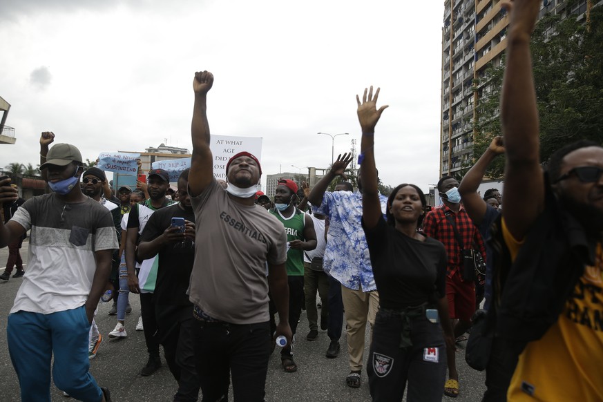 People demonstrate on the street to protest against police brutality in Lagos, Nigeria, Tuesday Oct. 13, 2020. Crowds protesting against police brutality in Nigeria have taken to the streets for a six ...