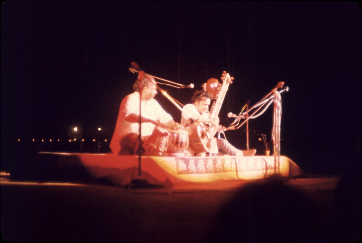 Indian musicians Ravi Shankar (center) and Alla Rakha (1919 - 2000) (left) perform on stage at the Woodstock Music and Arts Fair, Bethel, New York, August 15, 1969. With them, though obscured, is fell ...