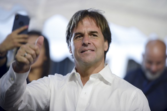 Opposition presidential candidate Luis Lacalle Pou makes a thumb up after a runoff elections in Montevideo, Uruguay, Sunday, Nov. 24, 2019. Uruguayans are choosing between Presidential candidate for t ...