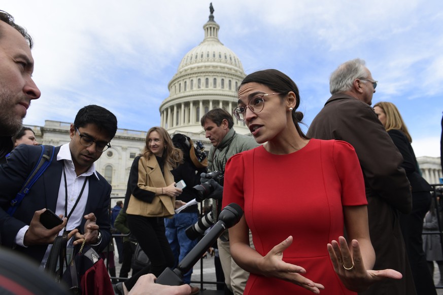 FILE - In this Nov. 14, 2018, file photo, Rep.-elect Alexandria Ocasio-Cortez, D-N.Y., talks with reporters following a photo opportunity on Capitol Hill in Washington, with the freshman class. Ocasio ...