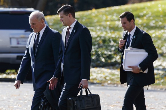 In this Nov. 29, 2017 file photo, White House Chief of Staff John Kelly, left, walks with White House staff secretary Rob Porter, center, and President Donald Trump&#039;s personal aide John McEntee t ...