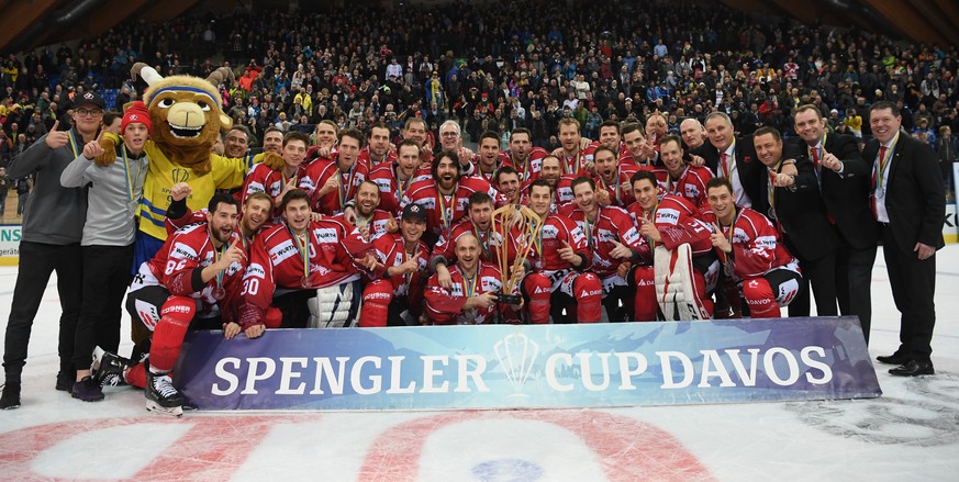 The players and the staff of Team Canada celebrate after winning the final game between Team Canada and HC Ocelari Trinec at the 93th Spengler Cup ice hockey tournament in Davos, Switzerland, Tuesday, ...