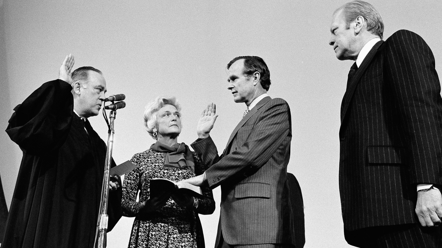 FILE - George H.W. Bush, center, is sworn in as director of the Central Intelligence Agency by Supreme Court Associate Justice Potter Stewart, left, as Barbara Bush and President Gerald Ford, right, l ...