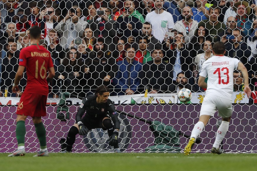 Switzerland goalkeeper Yann Sommer, center, fails to save the ball as Portugal&#039;s Cristiano Ronaldo scores the opening goal during the UEFA Nations League semifinal soccer match between Portugal a ...