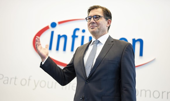 epa07990408 Infineon CFO Sven Schneider poses in front of a logo during the annual news conference at the Infineon headquarters in Neubiberg near Munich, Germany, 12 November 2019. According to offici ...