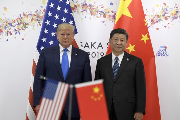 FILE - In this June 29, 2019, file photo President Donald Trump, left, poses for a photo with Chinese President Xi Jinping during a meeting on the sidelines of the G-20 summit in Osaka, Japan. China h ...