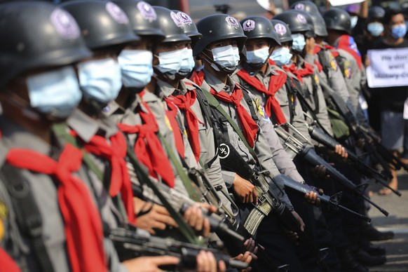 Armed riot police are seen near protesters in Naypyitaw, Myanmar on Monday, Feb. 8, 2021. Tension in the confrontations between the authorities and demonstrators against last week&#039;s coup in Myanm ...