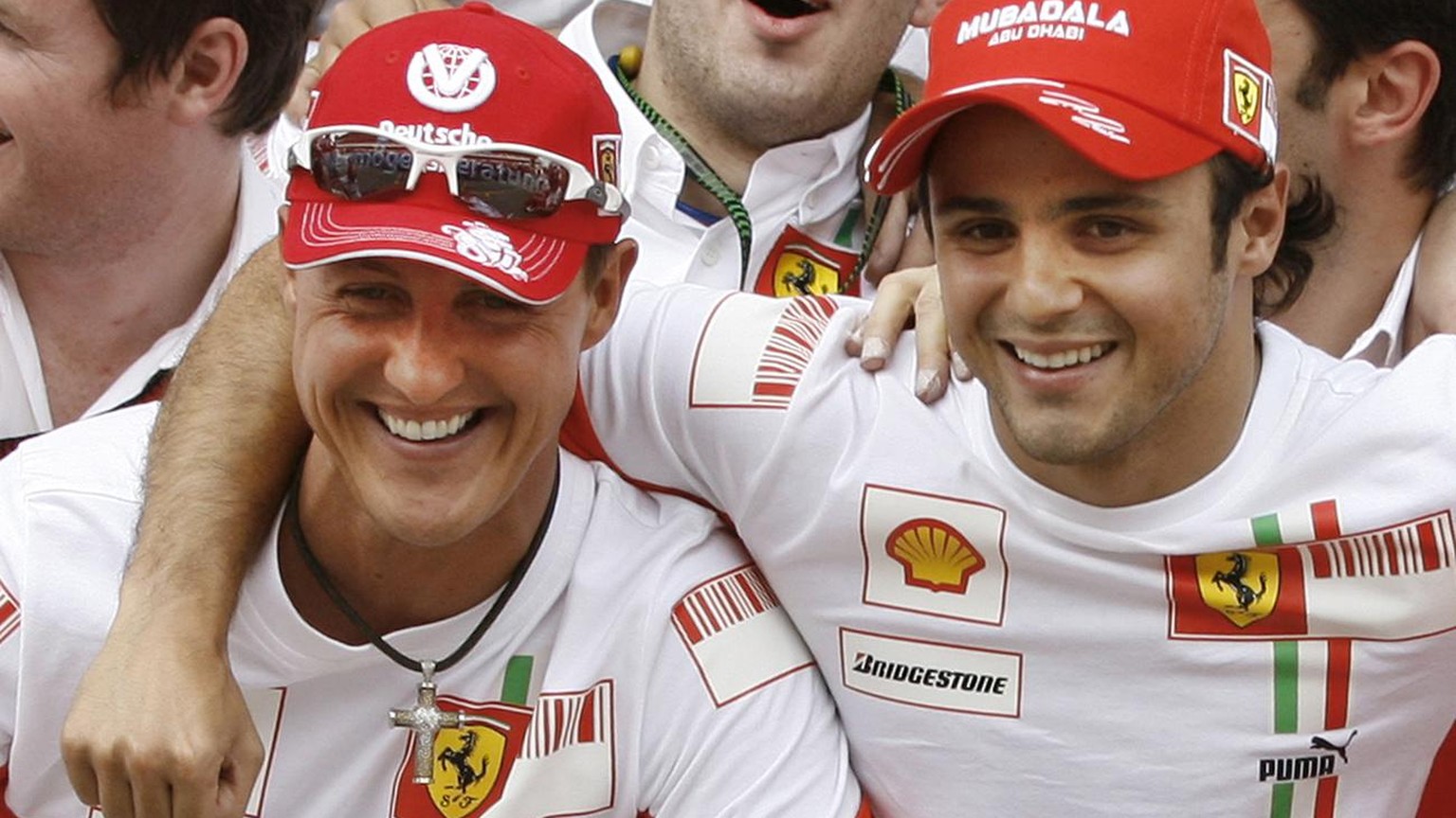 Brazilian Ferrari Formula One driver Felipe Massa, right, hugs former Ferrari star and seven times world champion Michael Schumacher, left, after winning the Spanish Grand Prix at the Montmelo racetra ...