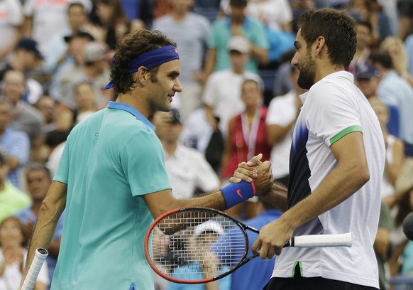 Roger Federer, of Switzerland, left, greets Marin Cilic, of Croatia, after losing to Cilic in their semifinal match of the 2014 U.S. Open tennis tournament, Saturday, Sept. 6, 2014, in New York. (AP P ...