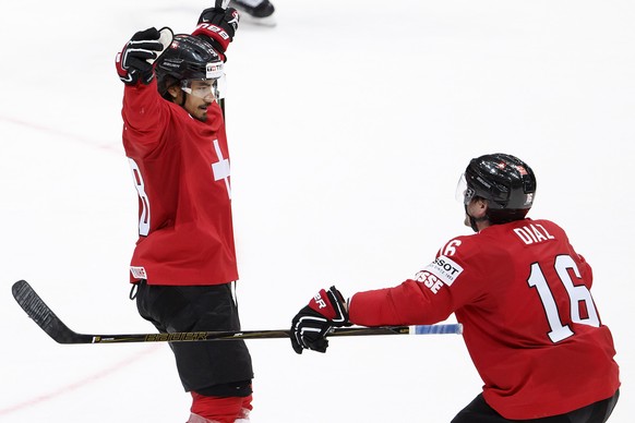 Switzerland&#039;s Eric Blum, left, celebrates his winner goal with teammate Raphael Diaz, right, after scoring during the overtime of the IIHF 2016 World Championship preliminary round game between S ...
