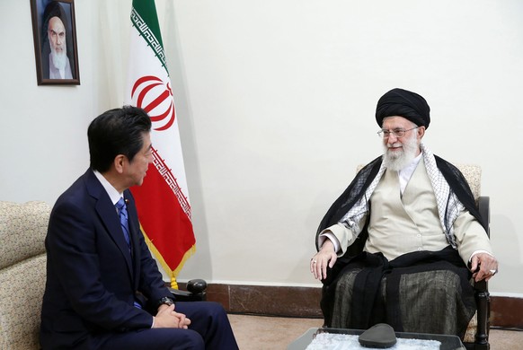 epa07644872 A handout photo made available by the Iranian supreme leader office shows Iranian supreme leader Ayatollah Ali Khamenei (R) talking to Japanese Prime Minister Shinzo Abe during a meeting i ...