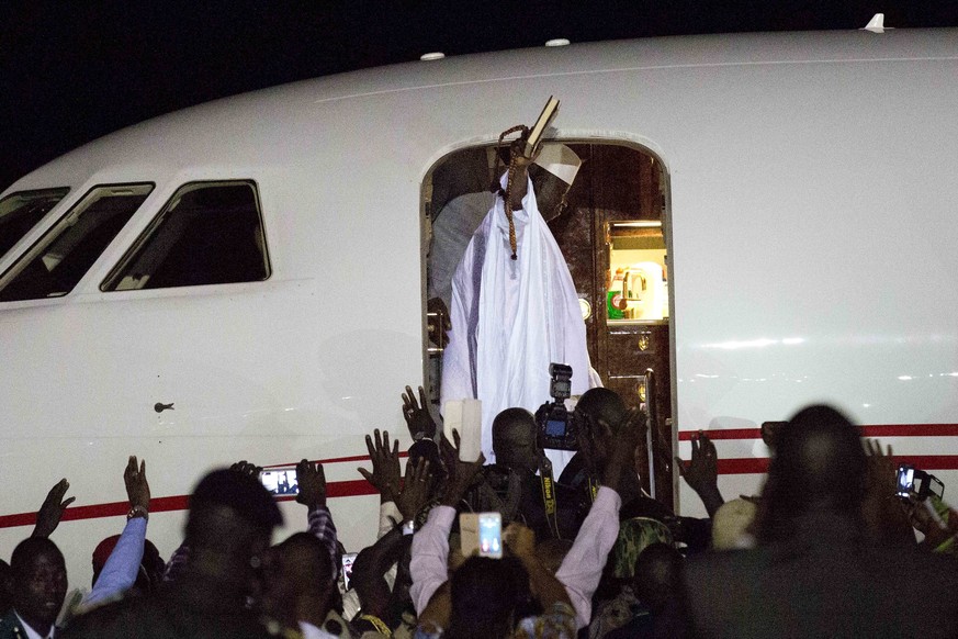 Gambia&#039;s defeated leader Yahya Jammeh waves to supporters as he departs from Banjul airport Saturday Jan. 21, 2017. Jammeh announced early Saturday he has decided to relinquish power, after hours ...