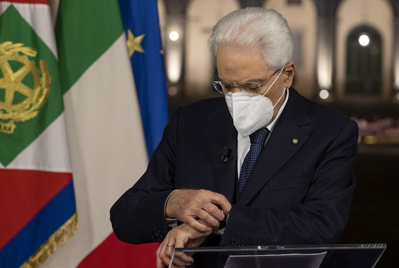 epa08913012 A handout picture made available by the Quirinal Presidential Palace (Palazzo del Quirinale) Press Office shows Italian President Sergio Mattarella getting ready to deliver his broadcasted ...