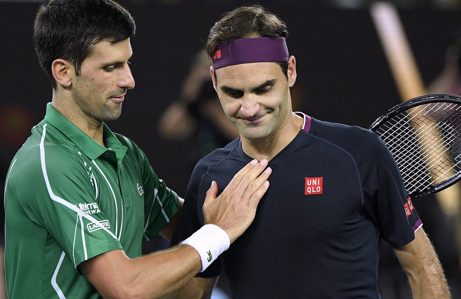 Switzerland&#039;s Roger Federer, right, congratulates Serbia&#039;s Novak Djokovic on winning their semifinal match at the Australian Open tennis championship in Melbourne, Australia, Thursday, Jan.  ...