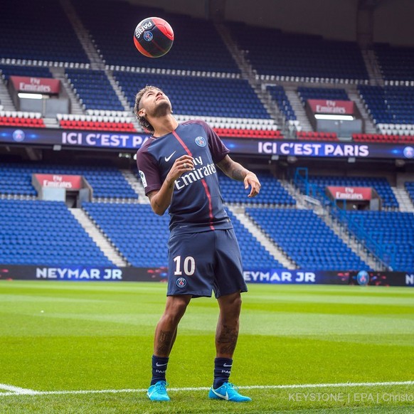 epa06260430 YEARENDER 2017 AUGUST..Brazilian striker Neymar Jr. poses for photographs with his new PSG jersey after a press conference at the Parc des Princes stadium in Paris, France, 04 August 2017. ...