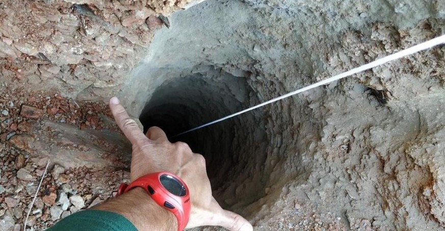 epa07285714 A handout photo made available by the Fire brigades of Malaga shows the 30 centimeters wide borehole in which a two-year-old fell down in the town of Totalan in Malaga, southeastern Spain, ...