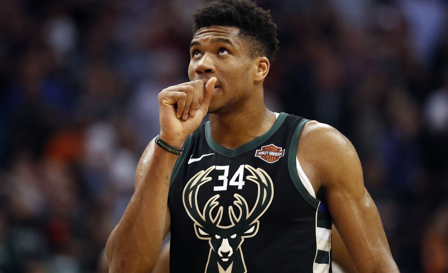 Milwaukee Bucks forward Giannis Antetokounmpo (34) looks at the scoreboard during the second half of an NBA basketball game against the Phoenix Suns, Monday, March 4, 2019, in Phoenix. (AP Photo/Matt  ...