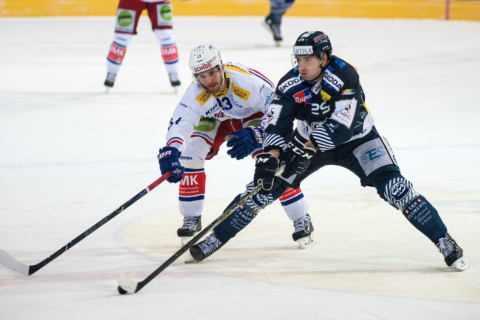 Kloten&#039;s player Patrick Obrist, left, fights for the puck with Ambri&#039;s player Michael Fora, right, during the placement round game of National League Swiss Championship 2017/18 between HC Am ...