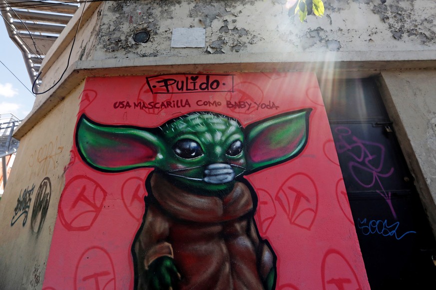 epa08332757 View of a graffiti drawn by artist &#039;Pulido&#039; for the character Baby Yoda, from the TV series &#039;The Mandalorian&#039;, wearing a mask and the message &#039;wear mask like baby  ...