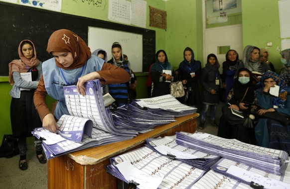 epa07108886 Workers of Independent Election Commission (IEC) count votes at a polling station after parliamentary elections in Kabul Afghanistan, 21 October 2018. At least five people were killed and  ...