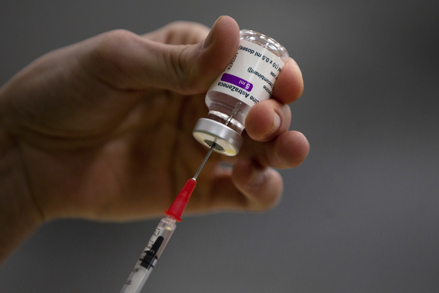 FILE - In this Friday, Feb. 19, 2021 file photo, a pharmacist prepares a syringe from a vial of the AstraZeneca coronavirus vaccine during preparations at the Vaccine Village in Antwerp, Belgium. Belg ...