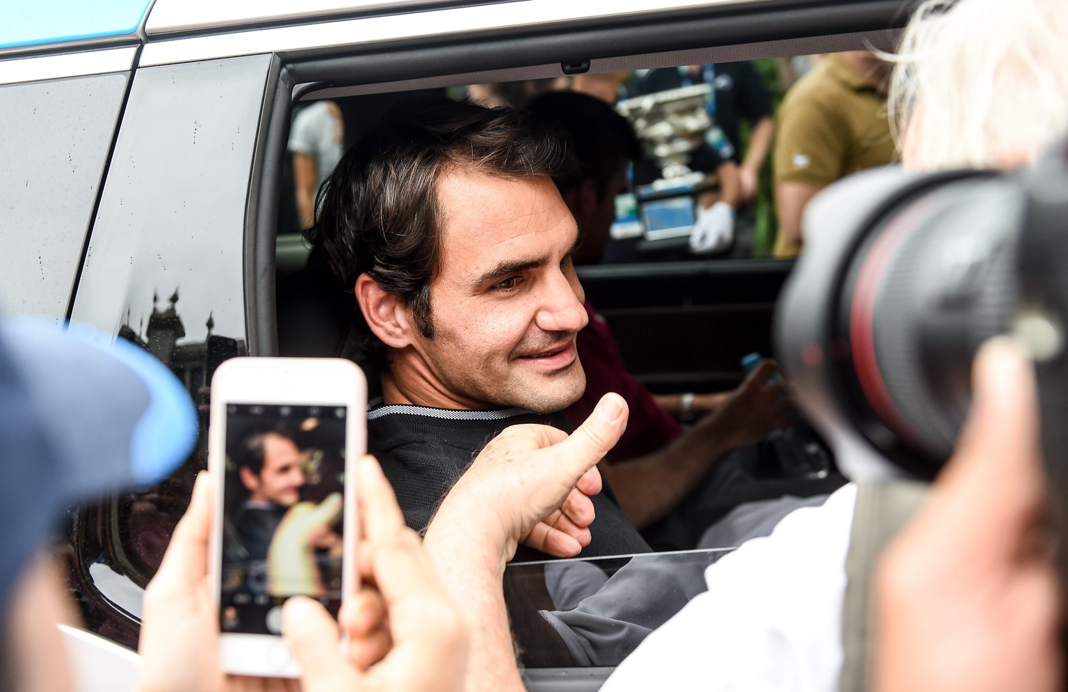 epa05760999 Switzerland&#039;s Roger Federer looks on from the window of a vehicle as he leaves after a photo shoot with his Australian Open Men&#039;s Singles trophy at Carlton Gardens in Melbourne,  ...