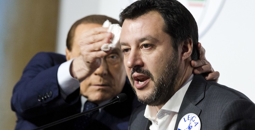 Forza Italia&#039;s Silvio Berlusconi, left, wipes the forehead of The League&#039;s Matteo Salvini at a media event for center-right leaders ahead of the March 4 general elections, in Rome, Thursday, ...