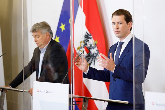 epa08789081 Austrian Chancellor Sebastian Kurz (R) speaks during a press conference next to Austrian Vice-Chancellor Werner Kogler (L) at the Austrian Chancellery in Vienna, Austria, 31 October 2020.  ...