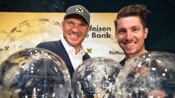 epa05227023 Austrian skier Marcel Hirscher (R) and former Austrian skier Hermann Maier (L) pose next to Hirscher&#039;s five overall FIS Alpine Skiing World Cup trophies during a press conference in V ...