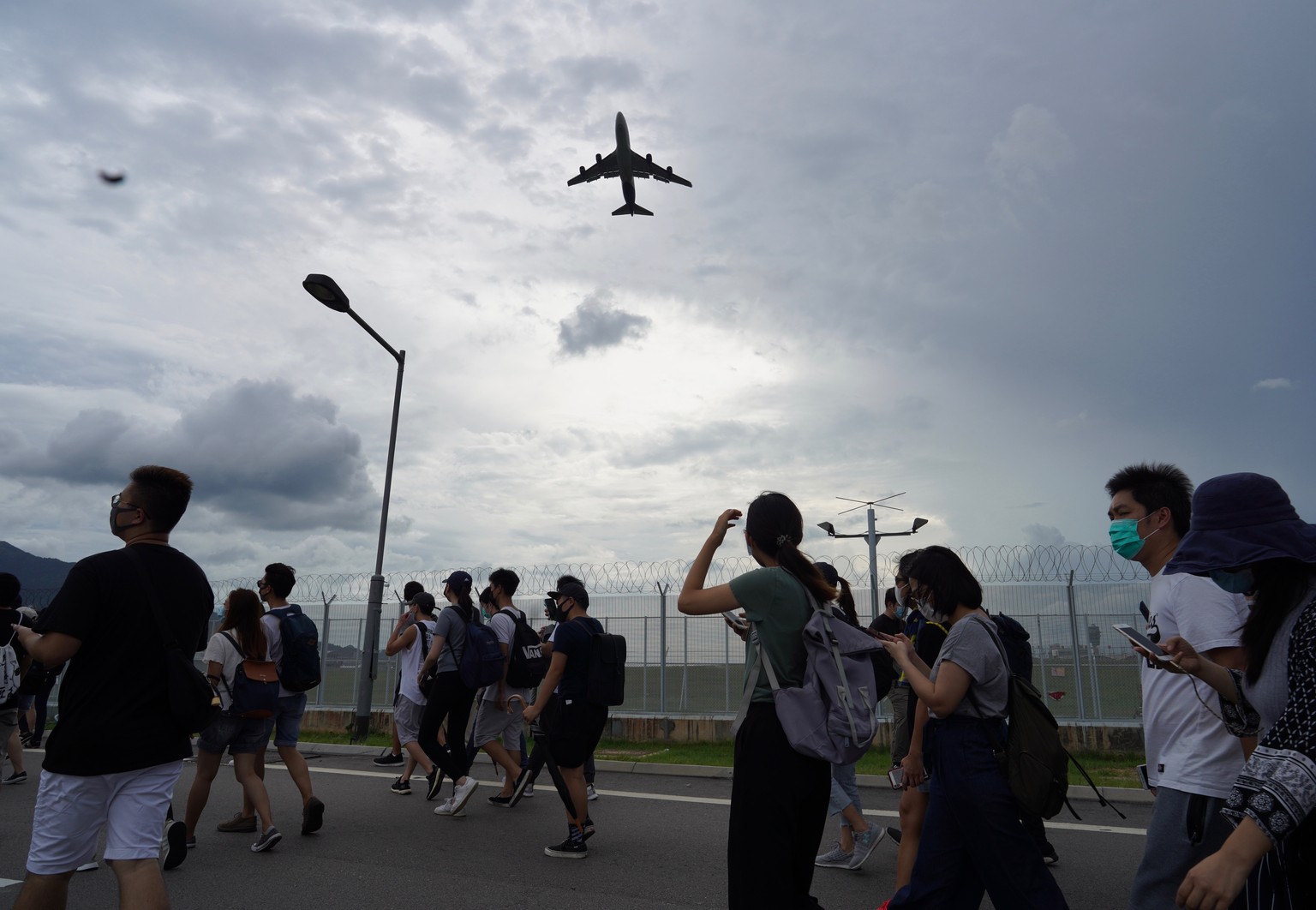 Pro-democracy protestors walk back after gathering outside the airport in, Hong Kong, Sunday, Sept.1, 2019. The operator of the express train to Hong Kong&#039;s airport has suspended service as pro-d ...