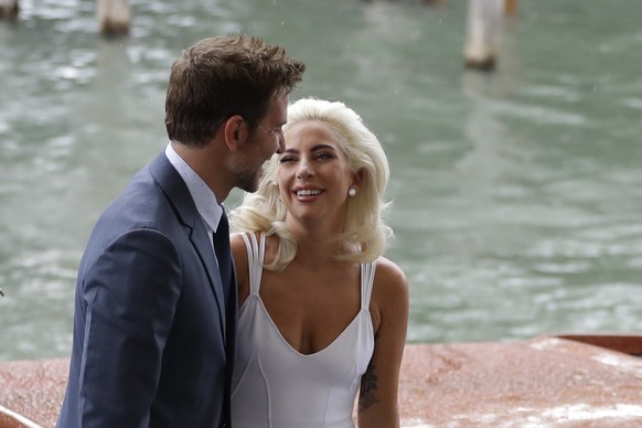Singer and actress Lady Gaga, right, and actor Bradley Cooper arrive for the photo call of the film &#039;A Star Is Born&#039; at the 75th edition of the Venice Film Festival in Venice, Italy, Friday, ...