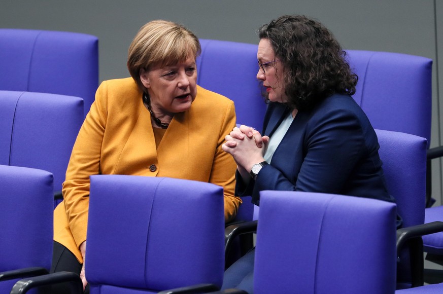 epa07435743 German Chancellor Angela Merkel (L) speaks with the leader of the Social Democratic Party (SPD) Andrea Nahles in the German parliament Bundestag in Berlin, Germany, 14 March 2019. The Germ ...