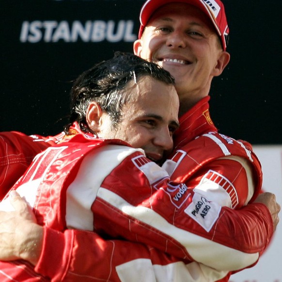 Ferrari Formula One driver Felipe Massa of Brazil, left, celebrates with his German team mate Michael Schumacher on the podium after winning the Formula One Turkish Grand Prix at the Istanbul Park rac ...