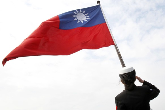 FILE - In this Jan. 31, 2018, file photo, a Taiwanese military officer salutes to Taiwan&#039;s flag onboard Navy&#039;s 124th fleet Lafayette frigate during military exercises off Kaohsiung, southern ...