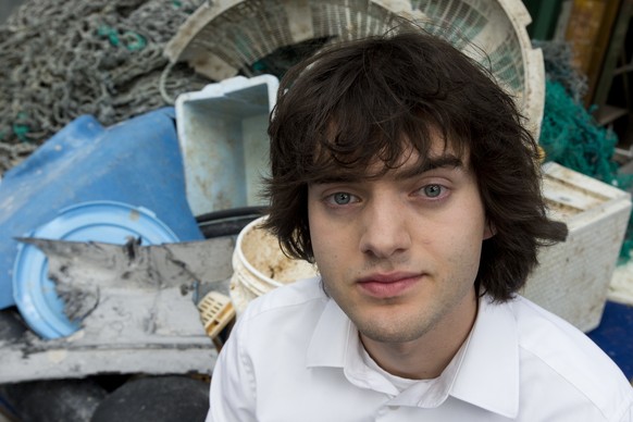 FILE - In this May 11, 2017, file photo, Dutch innovator Boyan Slat poses for a portrait next to a pile of plastic garbage prior to a press conference in Utrecht, Netherlands. Engineers will deploy a  ...