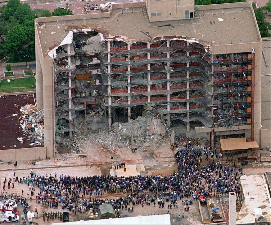 In this May 5, 1995 photo, thousands of search and rescue crews attend a memorial service in front of the Alfred P. Murrah Federal Building in Oklahoma City. More than 600 people were injured in the A ...