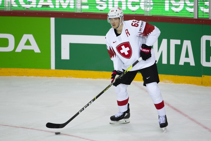 Switzerland&#039;s defender Ramon Untersander controls the puck, during the IIHF 2021 World Championship preliminary round game between Denmark and Switzerland, at the Olympic Sports Center, in Riga,  ...