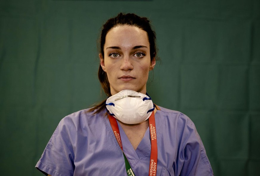 Martina Papponetti, 25, a nurse at the Humanitas Gavazzeni Hospital in Bergamo, Italy poses for a portrait at the end of her shift Friday, March 27, 2020. Their eyes are tired. Their cheekbones rubbed ...