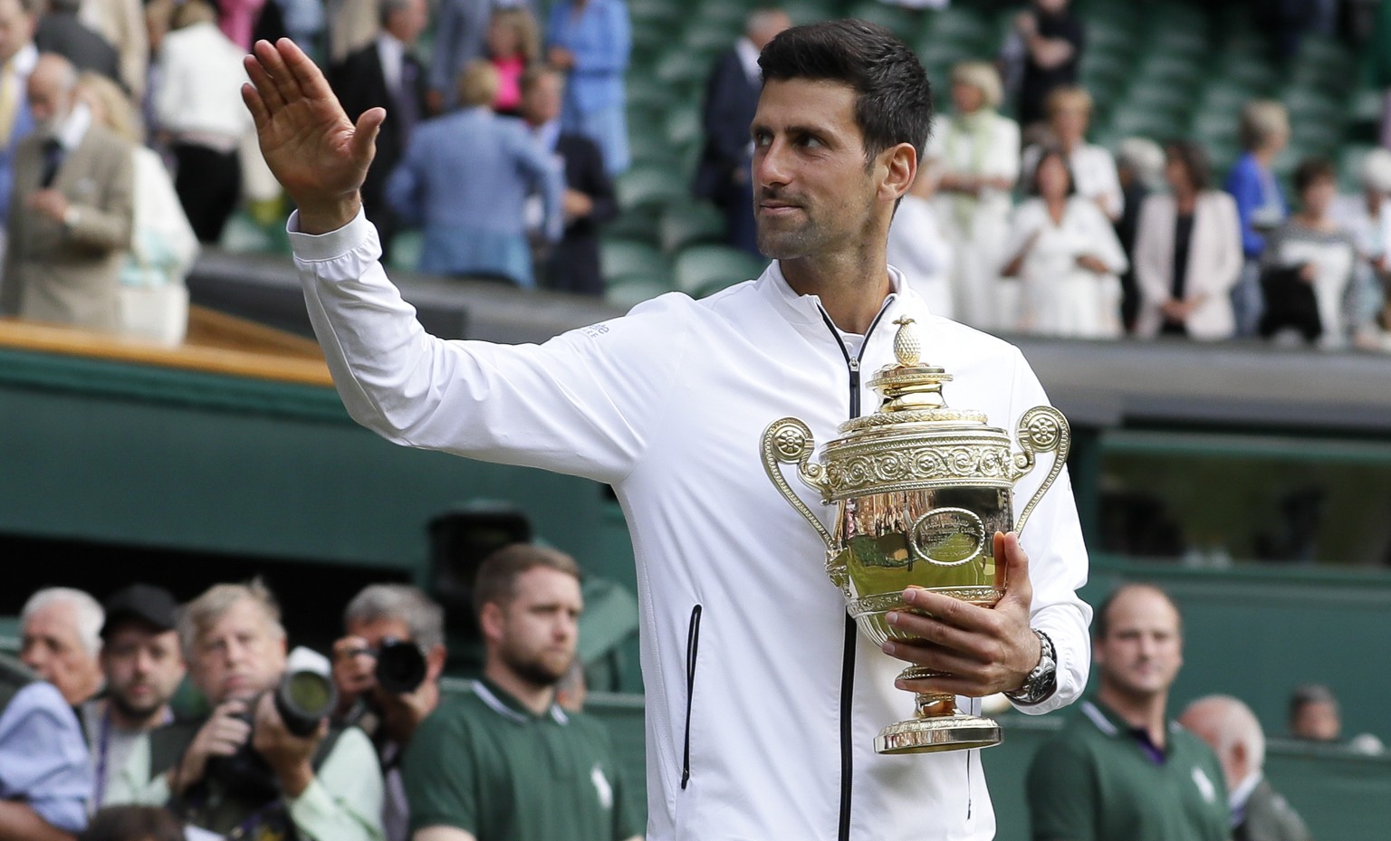 Serbia&#039;s Novak Djokovic holds the trophy after defeating Switzerland&#039;s Roger Federer in the men&#039;s singles final match of the Wimbledon Tennis Championships in London, Sunday, July 14, 2 ...